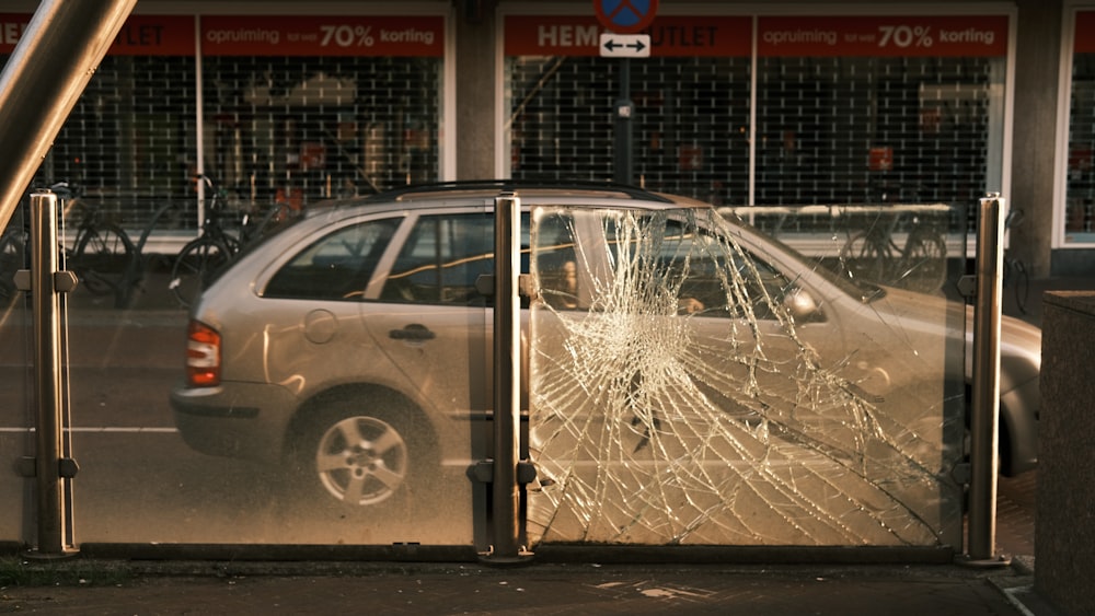 silver 5 door hatchback parked beside building