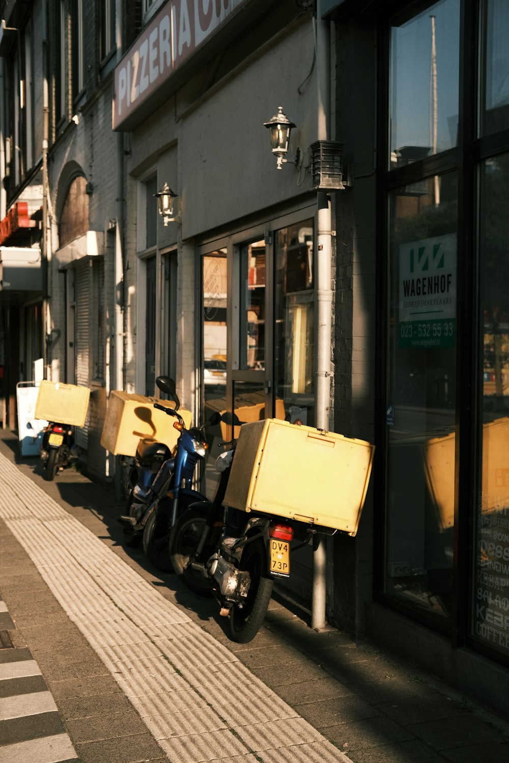 yellow and black motorcycle parked beside black motorcycle