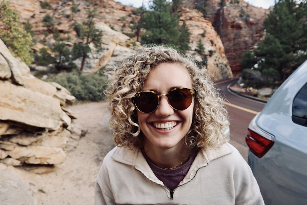 woman in brown jacket wearing brown sunglasses