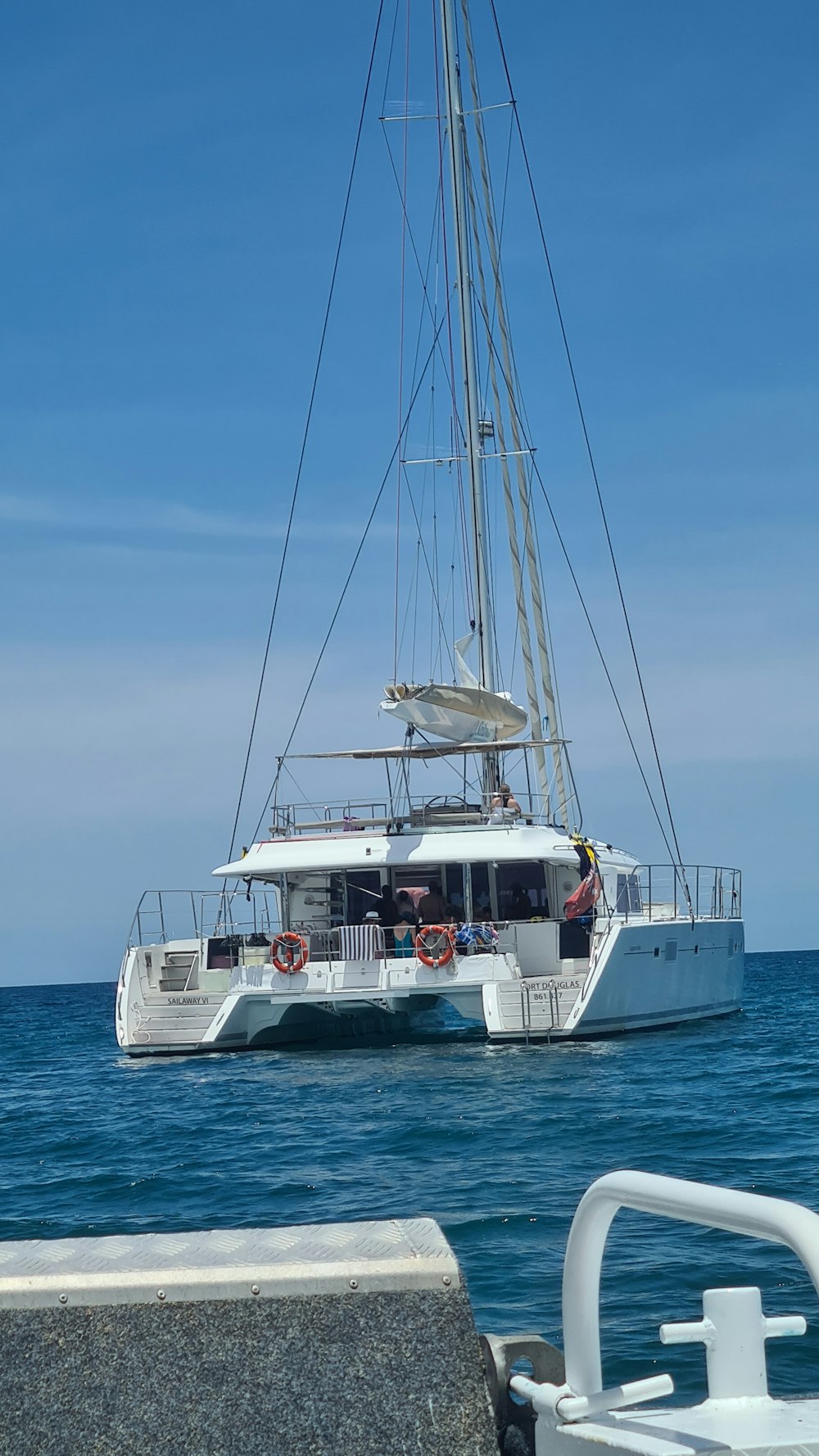 white sail boat on sea under blue sky during daytime