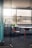 A clean and organized office space with sunlight streaming through the windows.