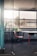 A clean and organized office space with sunlight streaming through the windows.