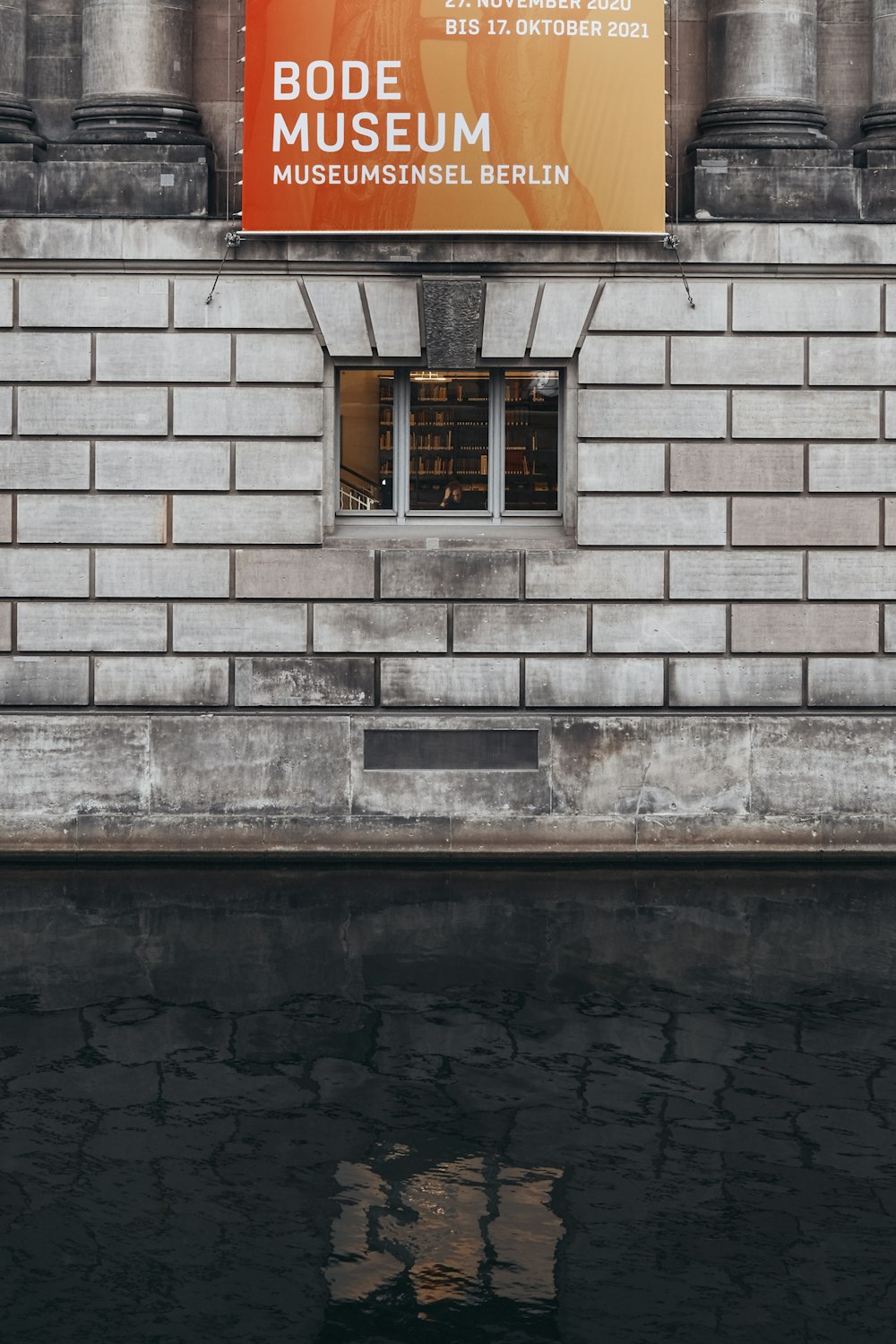 brown wooden window on gray brick wall