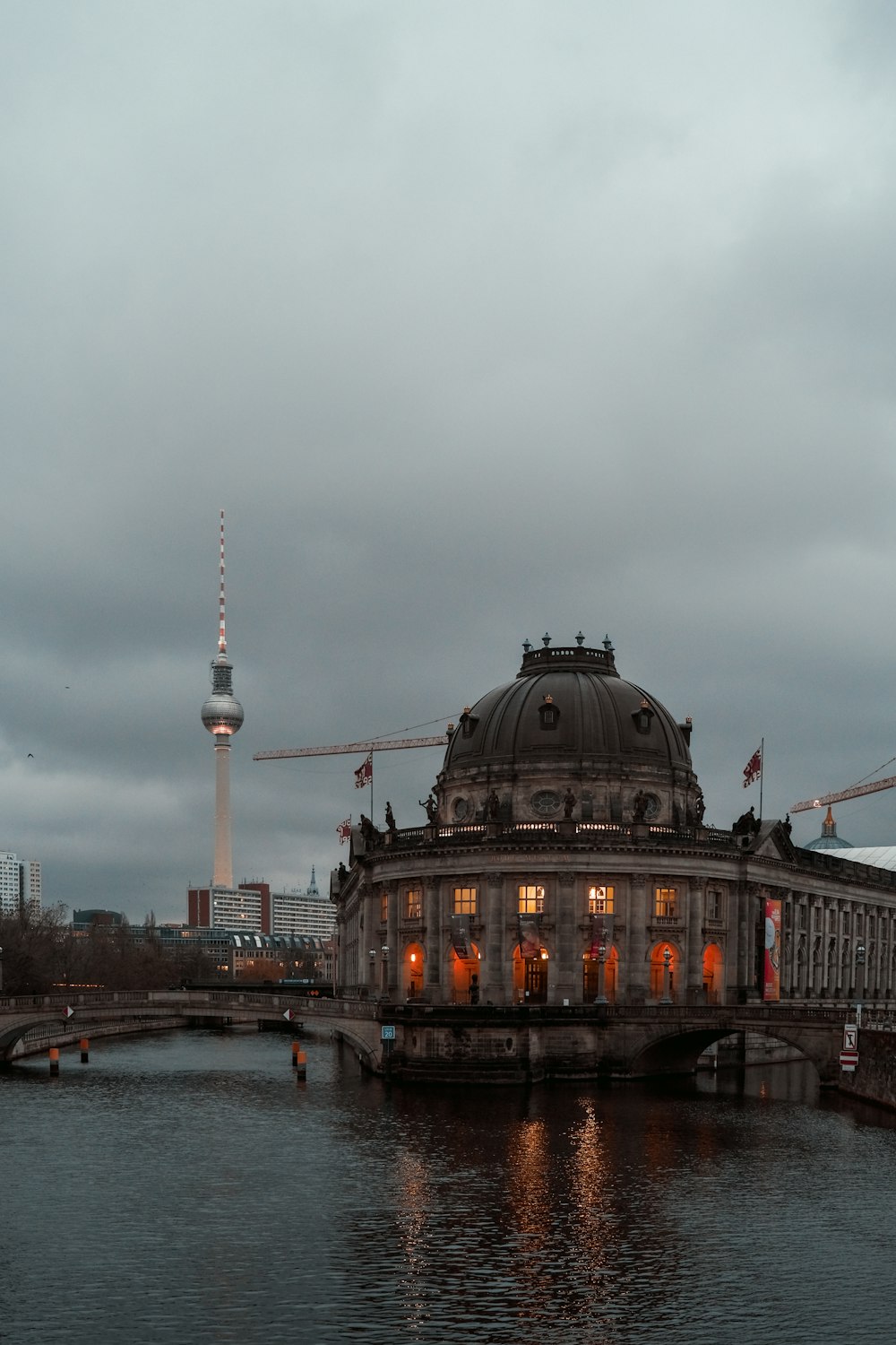 brown and gray concrete building near body of water during daytime