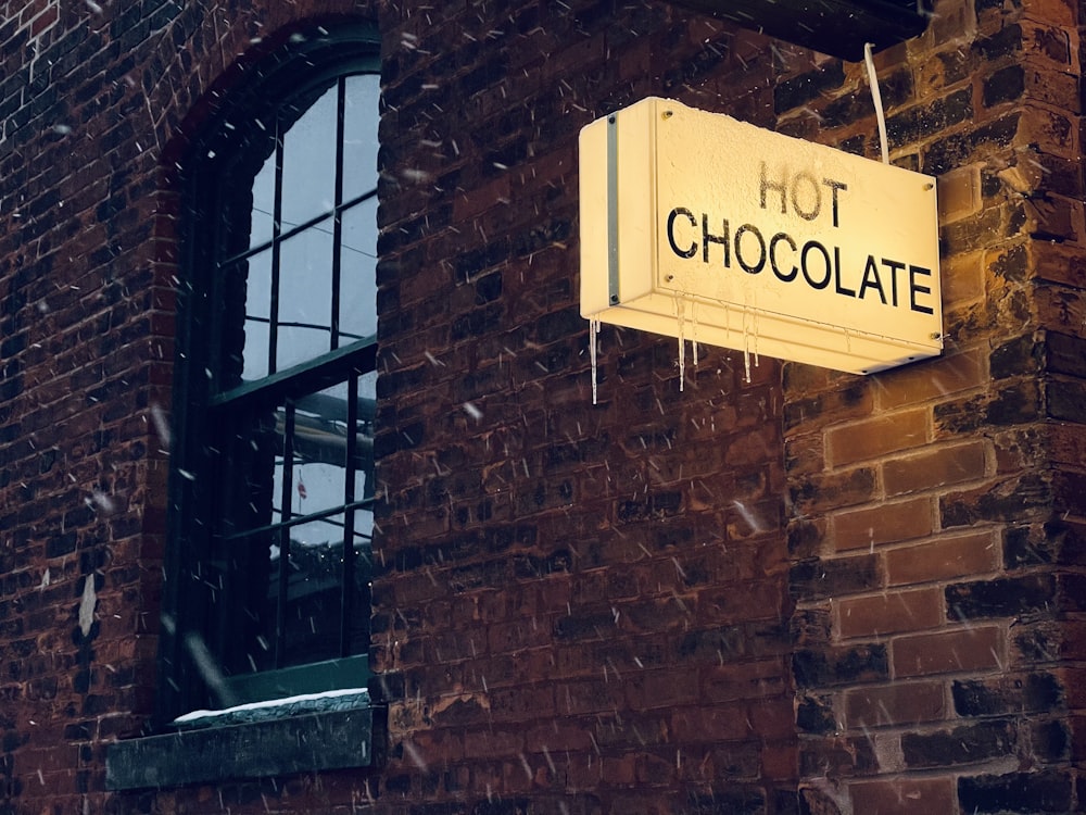 brown brick wall with brown wooden framed glass window