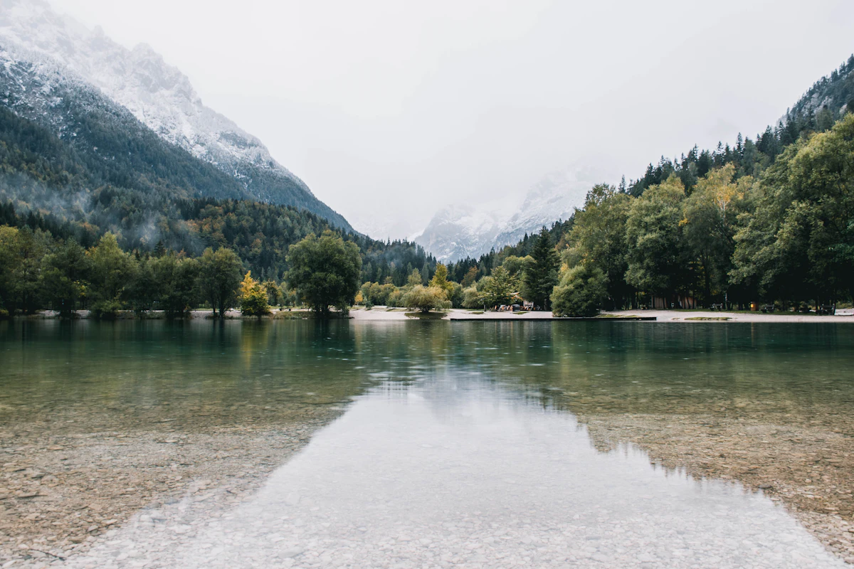 Lake Jasna near Kranjska Gora, with trees on the far shore and a mountain valley behind