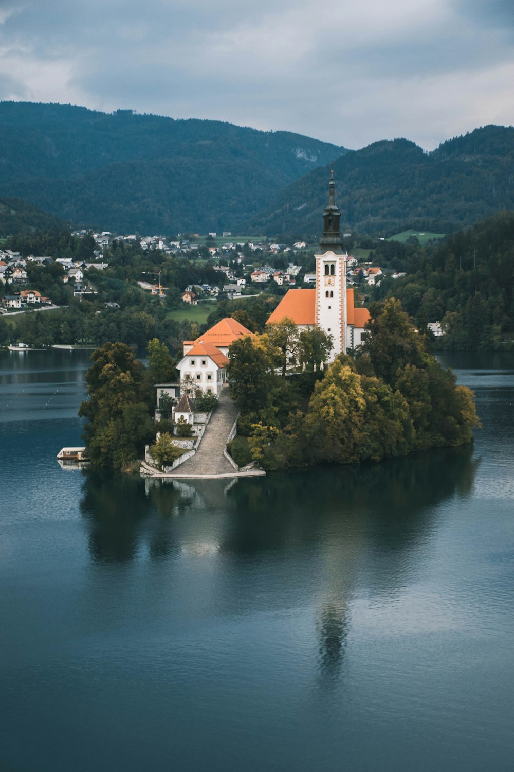 white and brown concrete building near body of water during daytime