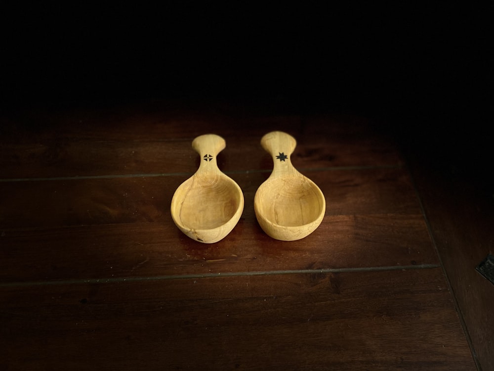 2 brown wooden vases on brown wooden table