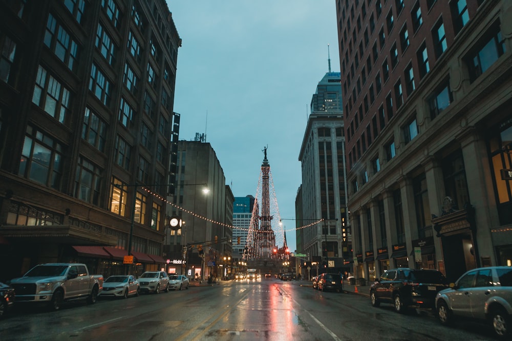 cars on road between high rise buildings during daytime