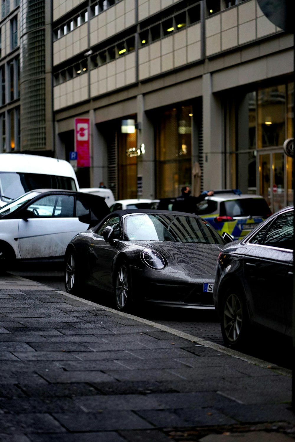 black mercedes benz c class parked on sidewalk during daytime