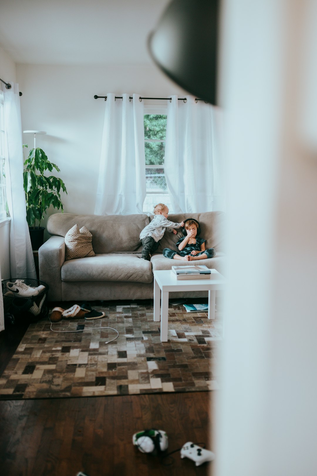 woman in gray long sleeve shirt sitting on gray couch