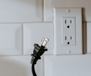 black usb cable plugged in white electric socket