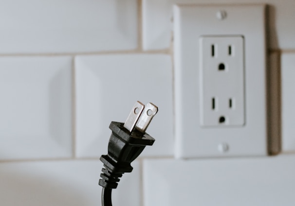 black usb cable plugged in white electric socket