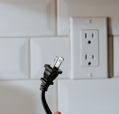 black usb cable plugged in white electric socket