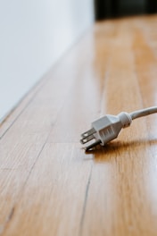 white usb cable on brown wooden table