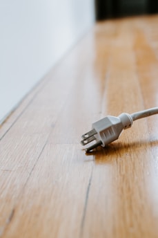 white usb cable on brown wooden table