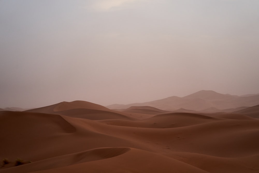 brown sand under white sky during daytime