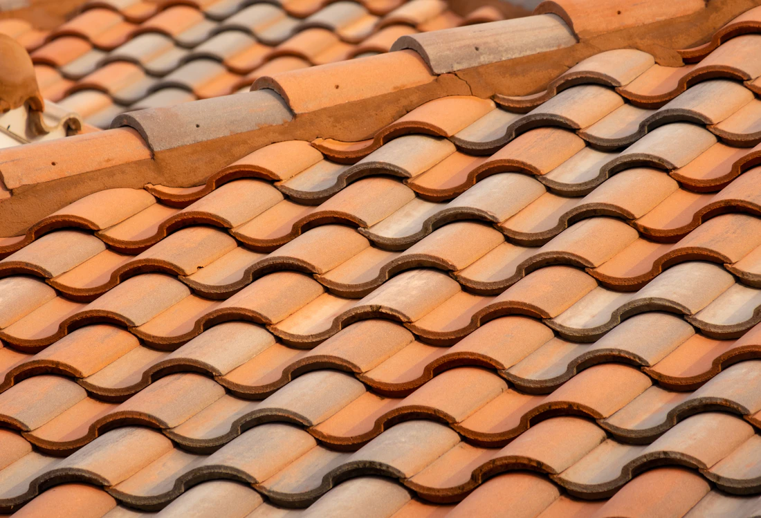 Close view of overlapping terracotta roof tiles