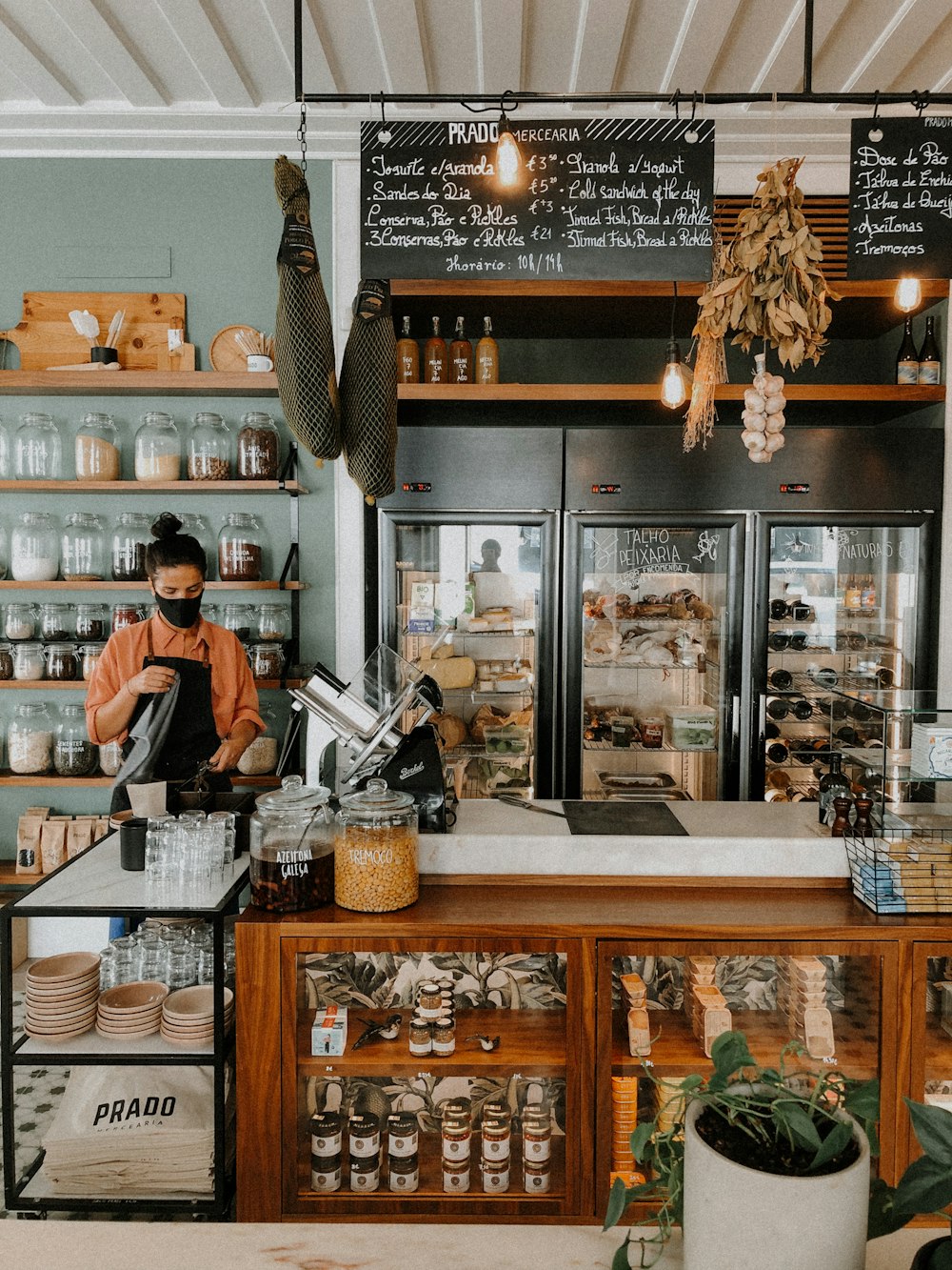 woman in black shirt standing in front of counter