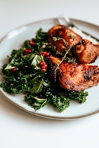 cooked meat with green vegetable on white ceramic plate