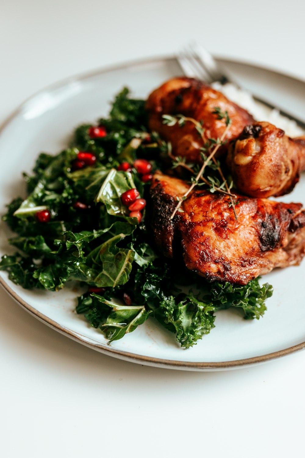 cooked meat with green vegetable on white ceramic plate