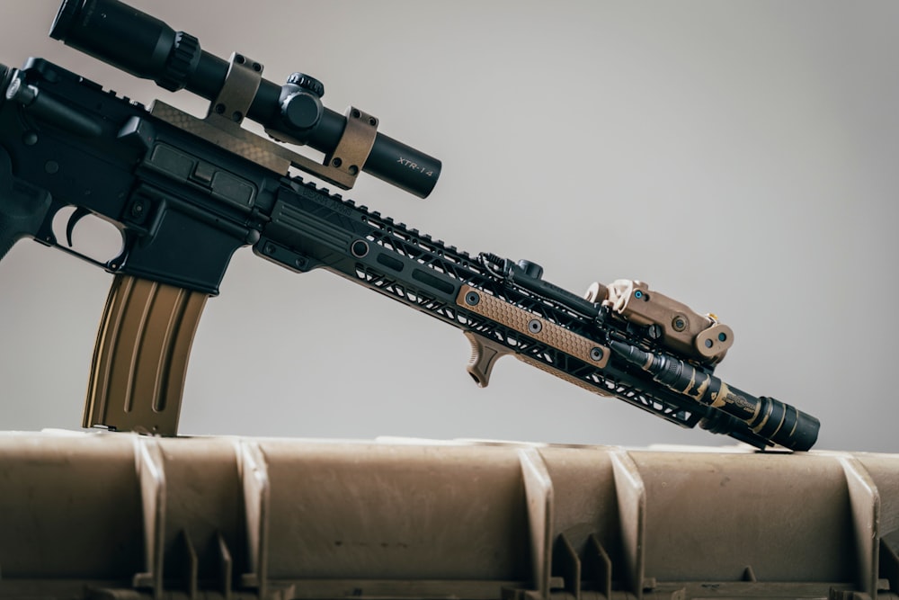 black rifle on brown textile