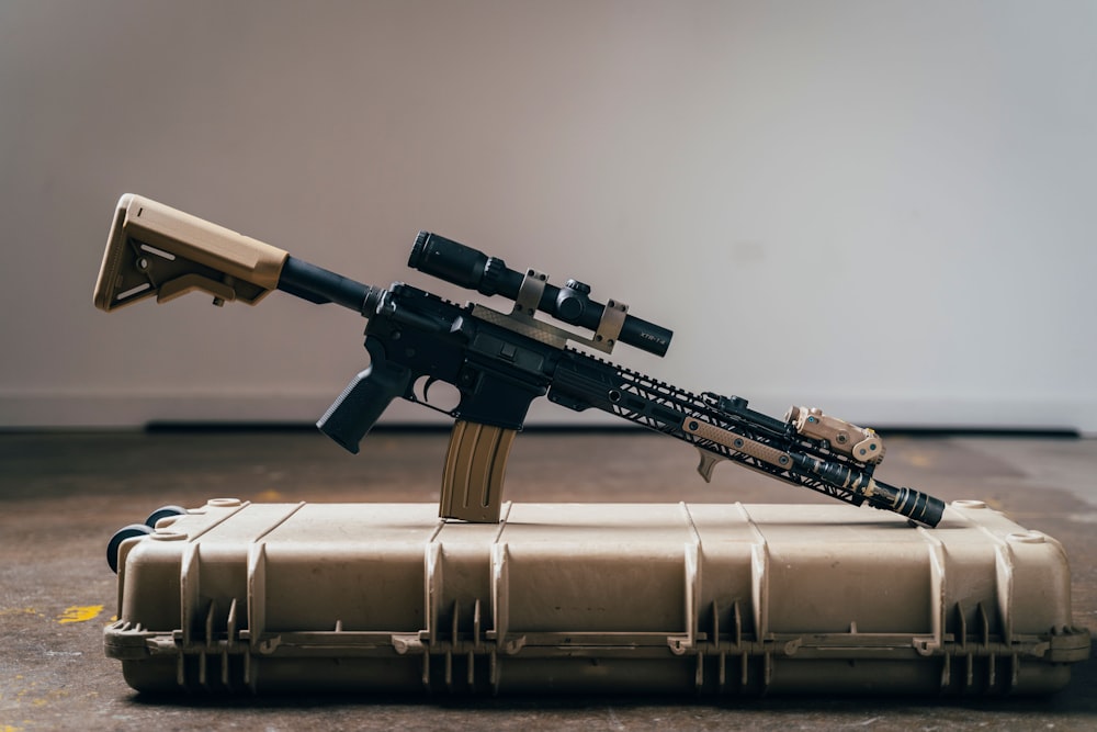 black rifle on brown textile