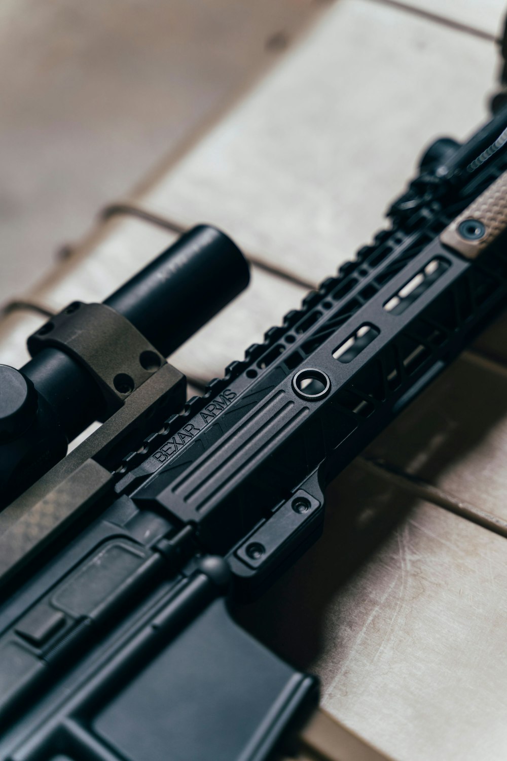 black rifle on brown wooden table