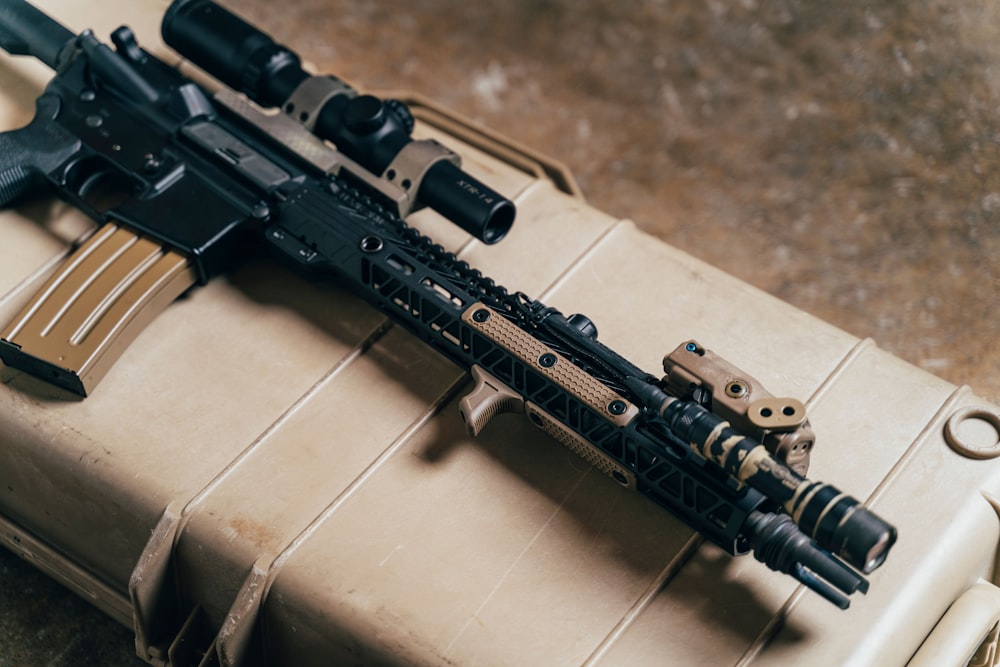 black rifle on brown wooden table