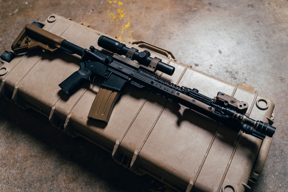 black rifle on brown cardboard box