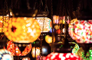 A set of handcrafted glass lanterns hanging in a softly lit dining area