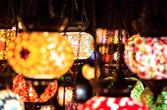 A set of handcrafted glass lanterns hanging in a softly lit dining area