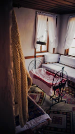 A cozy baby cradle softly lit in a pastel nursery room.