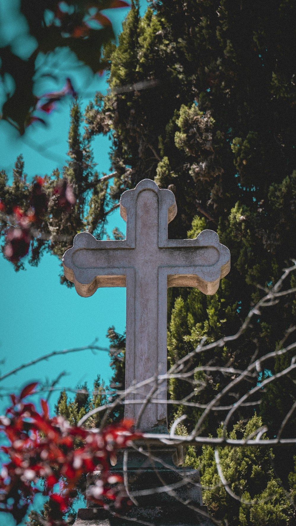 brown cross with red flowers