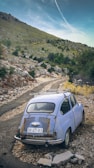 blue volkswagen t-2 on dirt road during daytime