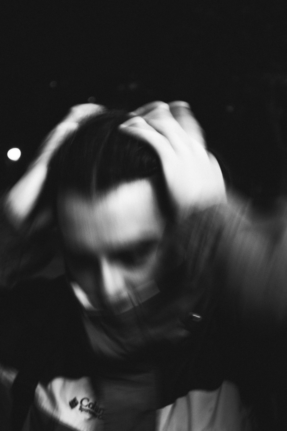 grayscale photo of woman covering her face with her hair