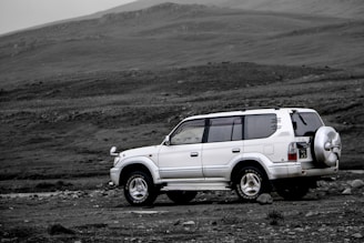 white suv on dirt road
