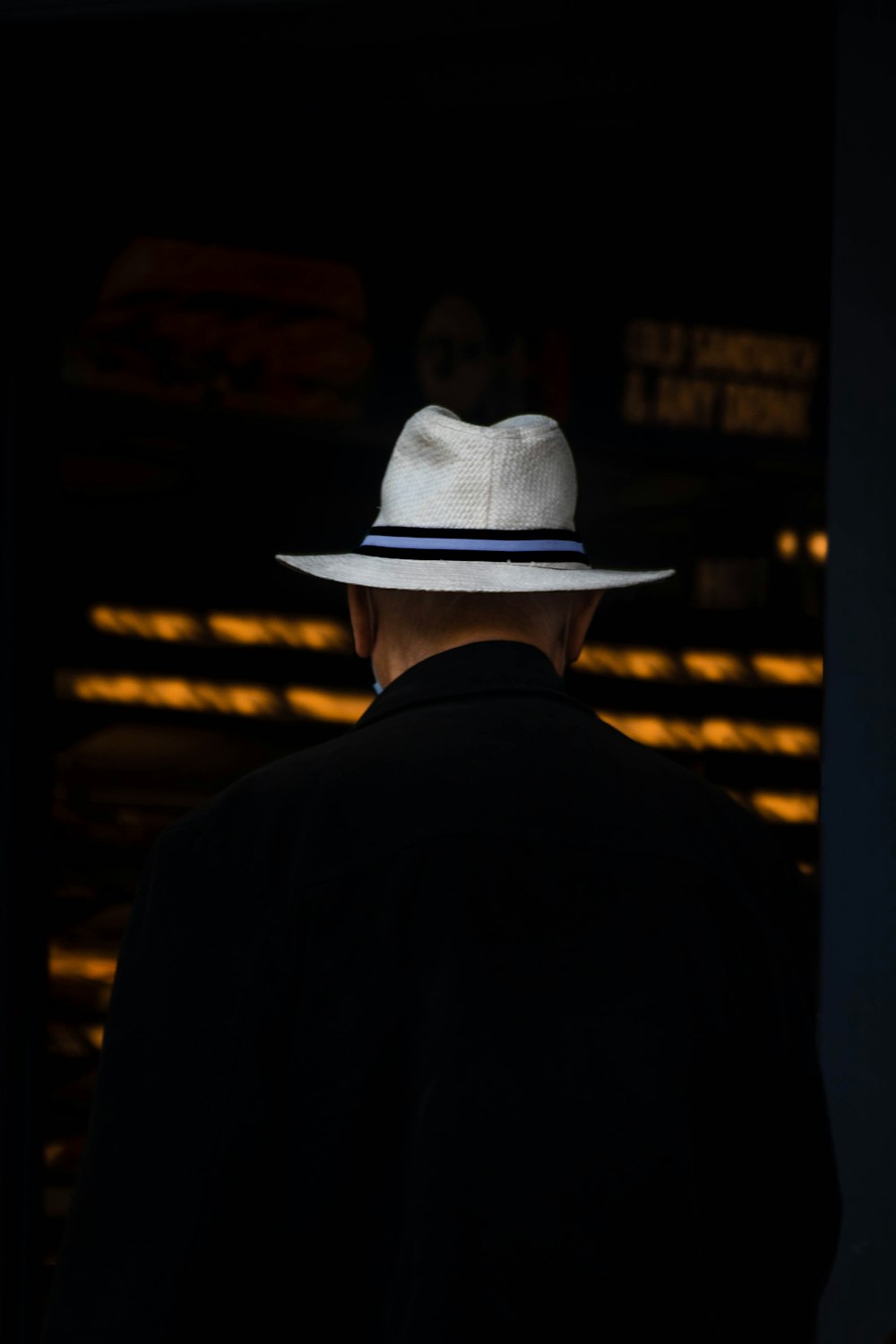 man in black suit wearing white cowboy hat