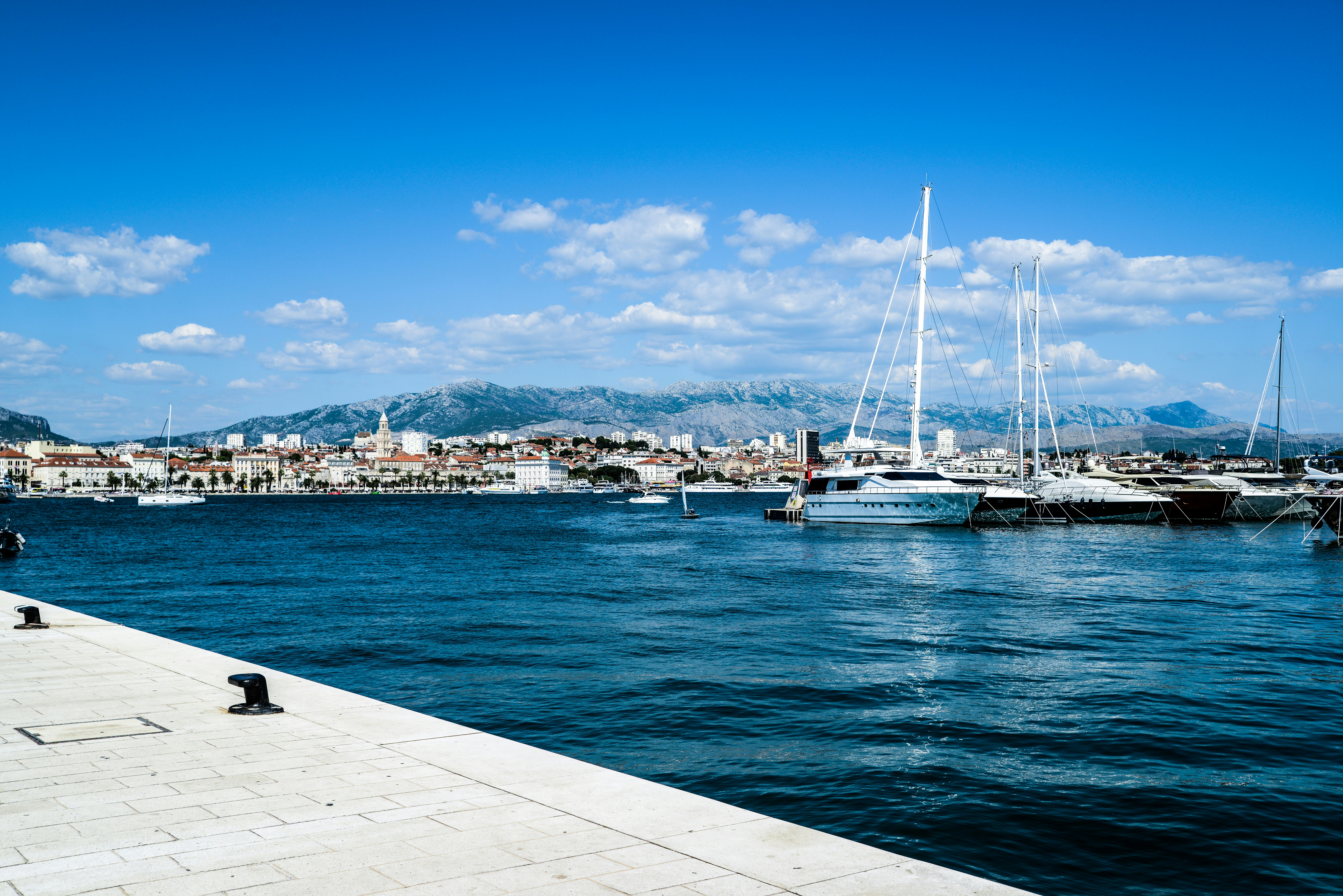 white boat on sea dock during daytime