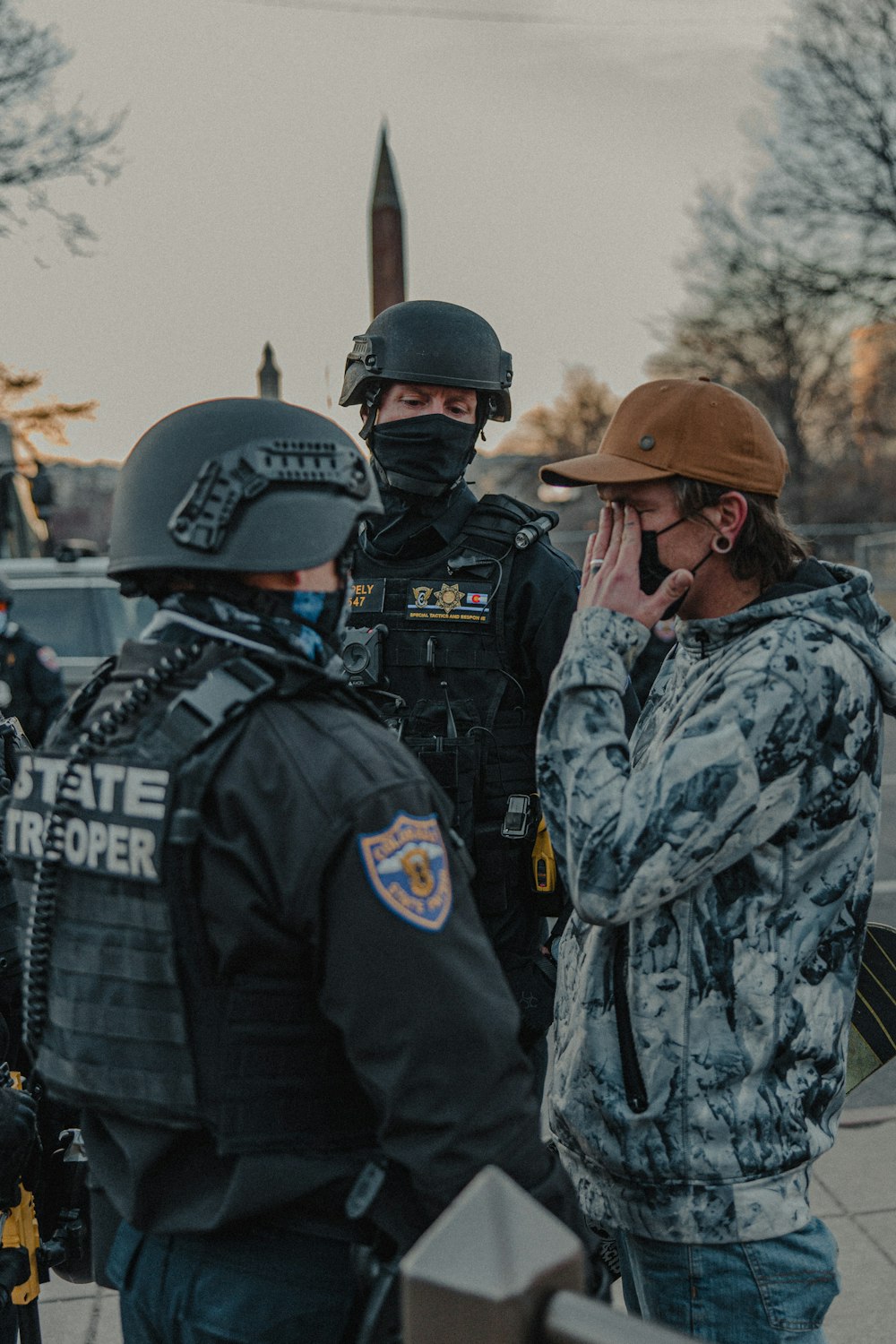 2 men in black and gray camouflage uniform