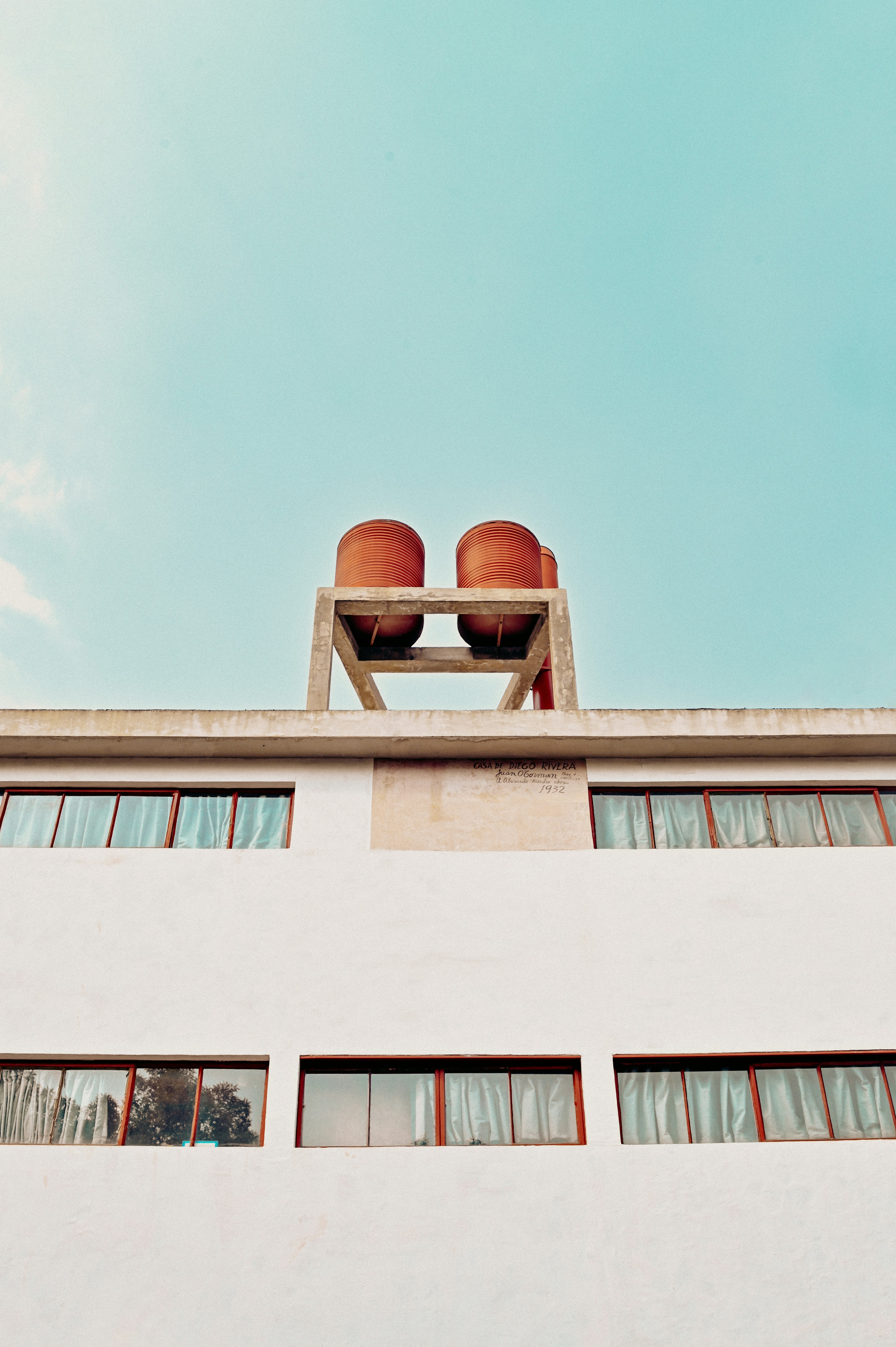 brown round outdoor lamp on white concrete building