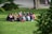 A group of men sitting in a circle, engaged in deep conversation outdoors.