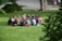 A group of men sitting in a circle, engaged in deep conversation outdoors.