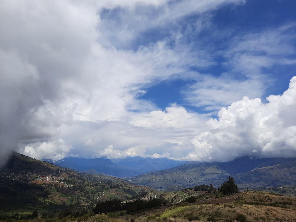 green mountains under white clouds and blue sky during daytime