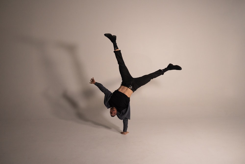 woman in black shirt and black pants jumping