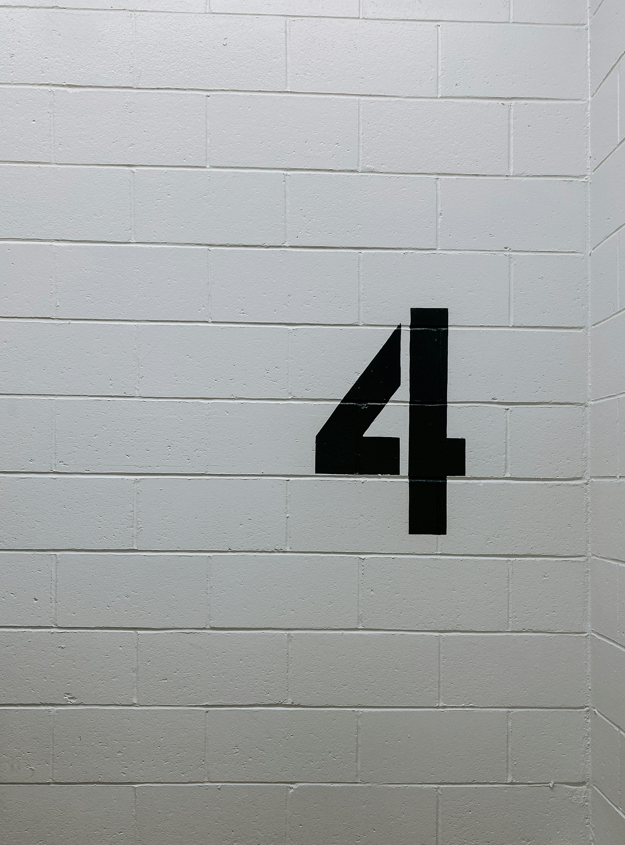 Number 4 painted on white bricks