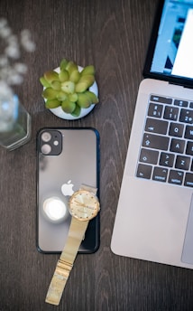 silver iphone 6 beside macbook pro