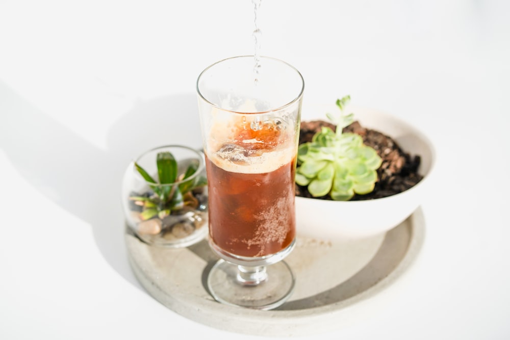 clear drinking glass with brown liquid