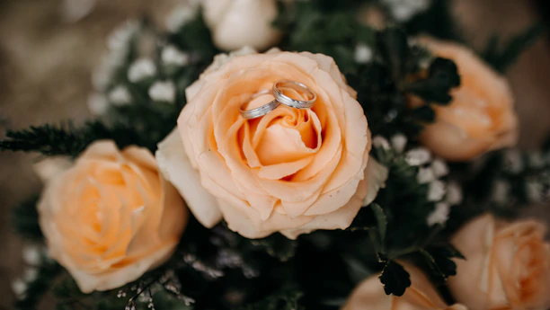 Close-up of a rose gold imitation ring with watermelon-inspired accents on a peach background.