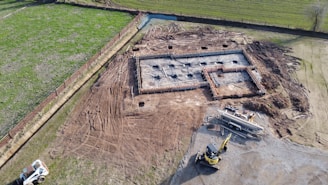 yellow and black heavy equipment on brown field during daytime